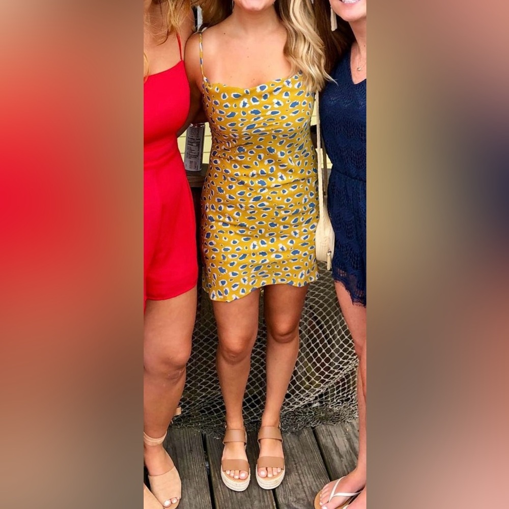 Boutique mini dress with crown neck line. Mustard and blue cheetah print.